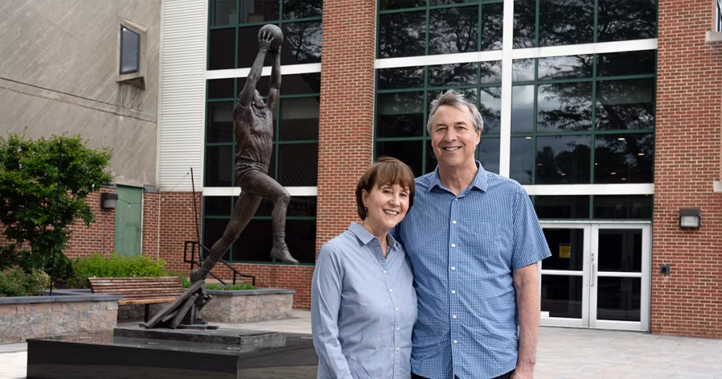 Ceil and Jim Tuman posing for a photo outside Univest Financial Fieldhouse.